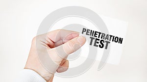 Businessman holding a card with text PENETRATION TEST, business concept