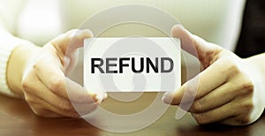 Businessman holding a card with text REFUND