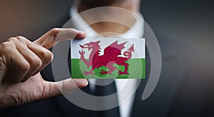 Businessman Holding Card of Wales Flag