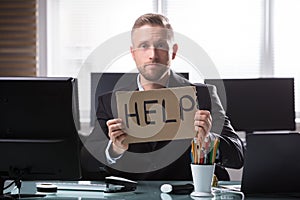 Businessman Holding Cardboard With Help Text