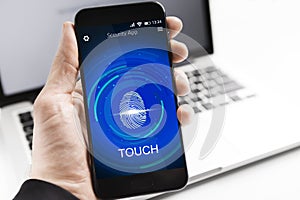 Businessman Holding Cellphone With Fingerprint Scanner Sitting At Workplace, Cropped