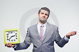 Businessman holding clock and copyspace