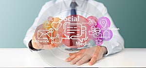 Businessman holding a cloud of social media network icon