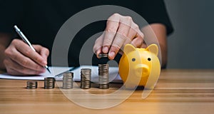 Businessman holding a coin in a piggy bank. money growth and saving money.