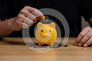 Businessman holding a coin in a piggy bank. money growth and saving money.