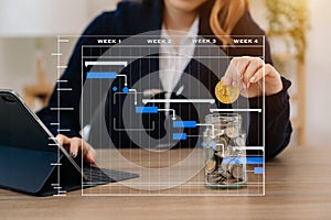 Businessman holding coins putting in glass with using smartphone and calculator to calculate concept saving money for finance