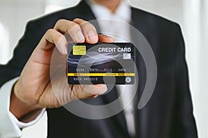Businessman holding credit card mockup . Plastic bank-card design mock up