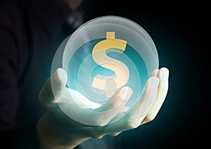 Businessman holding crystal ball with dollar sign