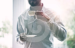 Businessman holding cup of coffee