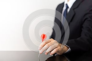 Businessman holding a dart