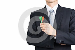 Businessman holding darts