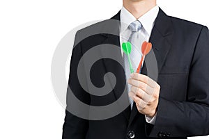 Businessman holding darts