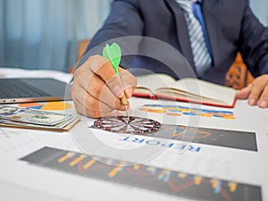 Businessman holding a darts aiming at the target center of dart board, Setting challenging business goals And ready to achieve