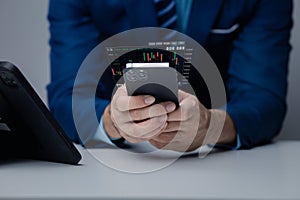 Businessman holding a device with a stock chart hologram, investing, using technology to invest in stocks. The concept of using