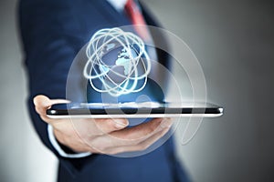 Businessman holding digital globe with mobiel phone