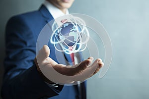 Businessman holding digital globe world in screen