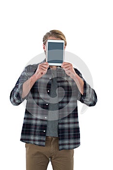 Businessman holding digital tablet in front of face