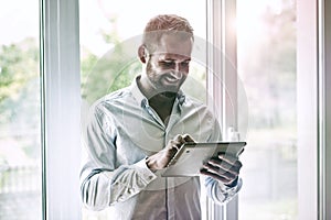 Businessman holding digital tablet touching with finger