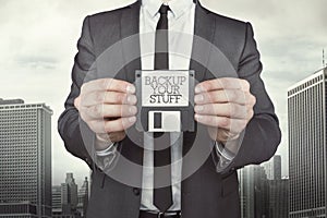 Businessman holding diskette in hands