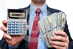 Businessman holding dollars in fan and calculator
