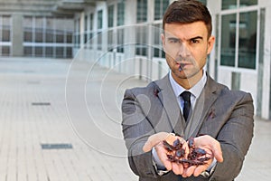 Businessman holding and eating roaches