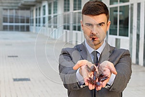 Businessman holding and eating roaches