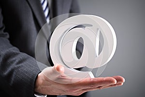 Businessman holding email at symbol