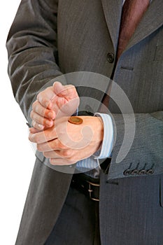 Businessman holding euro coin on hand. Close-up.
