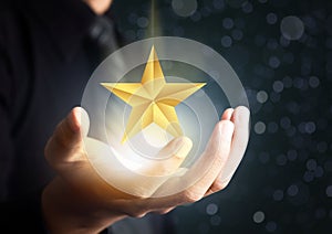 Businessman holding excellence star photo