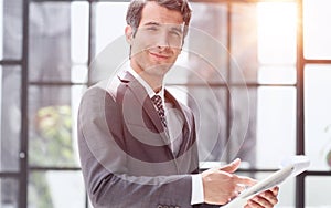 Portrait of a handsome young business man holding document folder