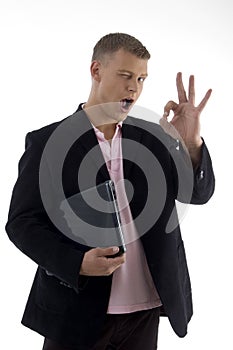 Businessman holding files and showing ok sign