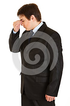 Businessman holding fingers at noseband