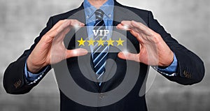 Businessman holding five star rating VIP - Grey - Stock Image