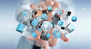 Businessman holding floating blue shiny cube network 3D rendering