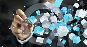 Businessman holding floating blue shiny cube network 3D rendering