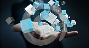 Businessman holding floating blue shiny cube network 3D rendering