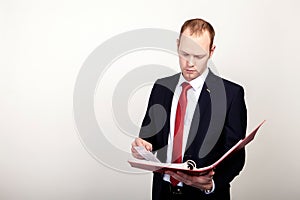 Businessman holding a folder on white