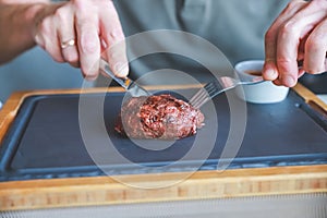 Businessman holding fork and knife eating steak, business and food.restaurant concept.eating stake from plate with fork