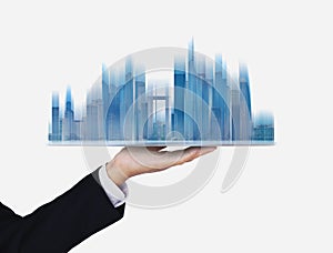 Businessman holding futuristic smart buildings hologram, on white background