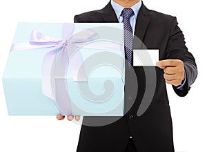 Businessman holding a gift box and a card.