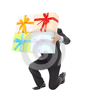 Businessman holding gifts and kneel down . isolated on white