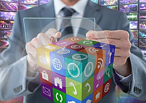 Businessman holding glass screen with apps with colorful screens visuals