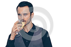 A businessman is holding a glass of wine and drinking with some