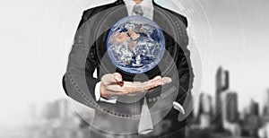 Businessman holding globe on hand. International business, environment reservation concept. Elements of this image are furnished b