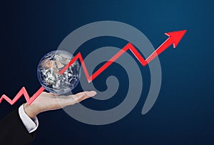 Businessman holding globe with raising arrow through the world, on blue background. Element of this image are furnished by NASA