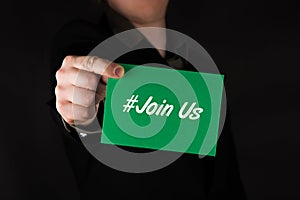 Businessman holding green card with text hashtag Join Us