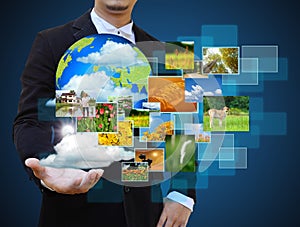 Businessman holding green Earth in hands