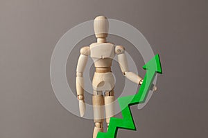 Businessman is holding a green up arrow. Deduction in the rise of indicators in the business at the expense of the leader