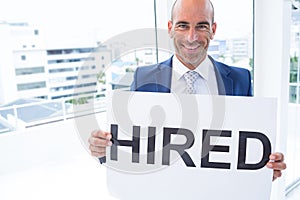 businessman holding a hired sign