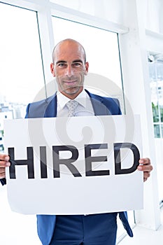 businessman holding a hired sign